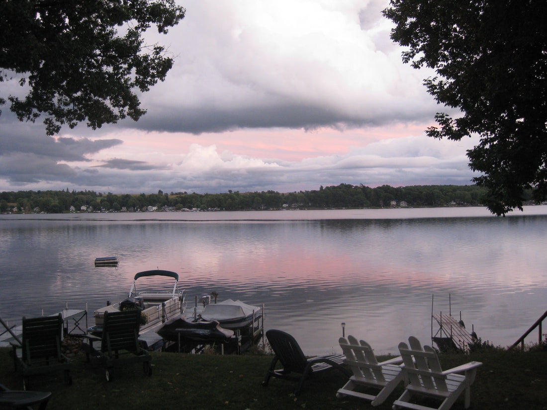 Beautiful sunset view of Silver Lake NY with dock and Adirondack chairs